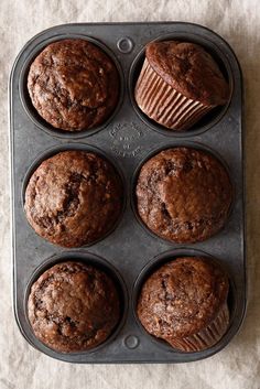 six chocolate muffins in a baking pan