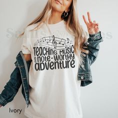 Teaching Music Is A Note Worthy Adventure | Music Teacher Shirt | Teach Tshirt | Gift For Teacher | Retro Teacher T-Shirt | New Teacher Gift **Note: FOR A RELAXED FIT, CHOOSE YOUR GO-TO SIZE. TO ACHIEVE AN OVERSIZED, LOOSE FIT, WE RECOMMEND GOING UP AT LEAST 1-2 SIZES. MODELS IN PHOTOS ARE WEARING 1-2 SIZES LARGER THAN THEIR GO-TO SIZE. ABOUT THIS AWESOME COMFORT COLORS T-SHIRT ... -These are Comfort Colors unisex garment-dyed t-shirts, made with 100% ring-spun cotton. They have UNISEX sizing - Music-themed White Relaxed Fit Top, White Cotton Music-themed Top, Music-themed White Cotton Top, White Music-themed Cotton Top, Teach Tshirt, Music-themed Relaxed Fit T-shirt With Letter Print, Music-themed Letter Print Crew Neck Shirt, Music-themed Crew Neck Shirt With Letter Print, Music-themed Cotton Top