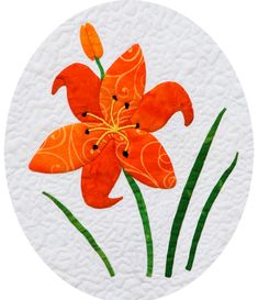 an orange flower with green leaves in the center on a white paper circle that says scriven quilting