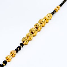 This exclusive striped 22k gold bracelet, weighing 5.2 grams, features an elegant yellow gold finish highlighted by sophisticated black beads. The bracelet's length of 7 inches, coupled with 0.6" adjustable links, offers a custom fit, secured with a hook lock. Ideal for those who appreciate a blend of classic elegance and contemporary design, this piece combines the luxurious allure of gold with the striking contrast of black beads, creating a distinguished accessory. Perfect for adding a refine Traditional Gold Beaded Bracelets For Formal Occasions, Gold Bracelets With Round Beads In 22k Gold, Traditional Gold Bracelet With Black Beads, Traditional Gold Beaded Bracelet With Black Beads, Gold Bracelet Jewelry With Black Beads, Gold Bracelet With Black Beads Jewelry, Traditional Gold Bracelets With Black Beads, Adjustable 22k Gold Bracelet, Black 22k Gold Jewelry With Round Beads