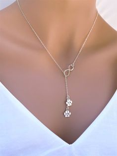 "Personalized Sterling Silver Infinity Paw Necklace.  it is perfect gift for pet lover. Unique gift. The paw print dangle will be flip when you are wearing.  The paw print charm can be add 1- 5 with add cost form drop down box. The Model wearing 17\", it could be shorter or longer  depend on customer's request from \" Necklace Length \" drop down box as you check out. Dangle paw print will not count on total necklace length. It consists of... -Sterling Silver 9.4x10.7mm 18 gauge Paw Print Charm, Paw Necklace, Pet Jewelry For People, Dog Paw Print Necklace, Adjustable Paw Print Jewelry For Anniversary, Adjustable Paw Print Jewelry As Gift, Silver Jewelry With Paw Print For Mother's Day, Silver Paw Print Jewelry As Gift, Mother's Day Silver Jewelry With Paw Print, Adjustable Paw Print Jewelry For Gift