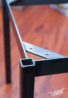 a close up of a metal rail on a wooden floor