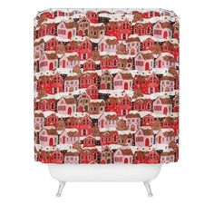 a red and white shower curtain with houses in the snow on it's side