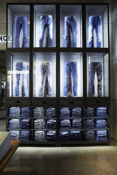 a display case filled with lots of blue jeans