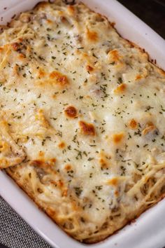 a square casserole dish with cheese and herbs