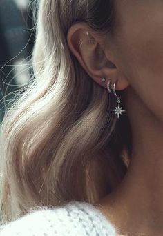 a close up of a person wearing earrings