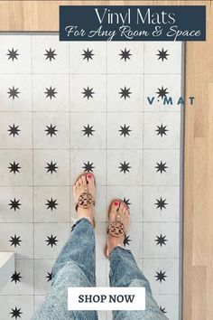 a person standing on top of a bathroom floor next to a white tile wall with black stars