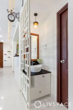 a bathroom with a sink, mirror and light fixture in it's center area