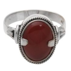 Twin prongs clasp a fiery carnelian in a silver embrace. Bright as a dragon's eye the gemstone centers a ring by Wayan Sarjana. Carnelian is believed to inspire action movement eloquence and courage; it fosters feelings of well-being. .925 Sterling silver Silver Carnelian Rings Spiritual Style, Silver Carnelian Spiritual Ring, Spiritual Carnelian Ring Jewelry, Silver Carnelian Ring, Adjustable Silver Carnelian Rings, Spiritual Carnelian Cabochon Rings, Single Stone Ring, Carnelian Ring, Dragon Eye