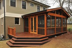 a house with a screened porch and stairs