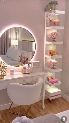 a white desk with a mirror and some lights on it in front of a bed