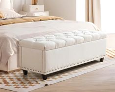 a white bed sitting on top of a wooden floor