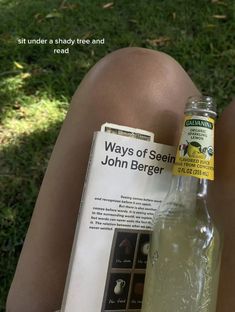 there is a bottle of john berger on the grass