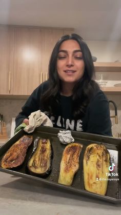 a woman holding a tray full of food