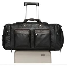 Introducing the Elegant Weekender Travel Duffle Bag, a perfect companion for your travel and gym needs. This stylish bag features multiple compartments, including a dedicated shoe pocket, ensuring your belongings are organized and easily accessible. Features: Material: Made from high-quality faux leather, offering durability and a sophisticated look. Design: Features a sleek design with multiple front zippered pockets, a shoe compartment, and a detachable strap for versatile carrying options. Sp Functional Leather Luggage For Weekend Trips, Black Travel Bag With Pockets For Weekend Trips, Functional Leather Travel Bag For Weekend Trips, Functional Leather Travel Bag, Multifunctional Travel Bag With Pockets, Sporty Black Travel Bag For Trips, Multifunctional Travel Duffle Bag With Luggage Sleeve, Functional Leather Duffle Bag, Versatile Black Leather Luggage