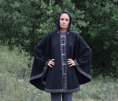 Long woolen poncho on the frog closure in Black or Navy color - Dark blue almost black. The poncho is hooded. One size: length 82 cm / 32 inches I will contact you to clarify your height to be sure the poncho will be perfect for you. Suitable for S, M, L, XL, XXL sizes Made in Estonia. It has the best possible quality. Made out of lambswool. I make exclusive woolen products made on the basis of the national traditions of Scandinavia and the Nordic countries. This product is soft and warm. Perfec Black Cape For Larp, Black Long Sleeve Cape For Larp, Black Wool Cape Poncho, Knitting Patterns Hats Women, Motif Fair Isle, Frog Closure, Crochet Winter Hats, Hats Women, Ladies Poncho