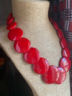 This feature necklace is made with beautiful round flat Red Crackle beads. The screw fastening is incorporated inside the bead.  No metal touches the skin. HANDMADE & FAIRTRADE Other colours are available in this necklace. Please look at our shop to find other colour options.Length:  Approximately 63 cm.  Beads: 2.5cm. Items posted to addresses within the UK will be sent Royal Mail 1st Class UK Standard. International post will be sent Royal Mail International Tracked & Signed. Red Beaded Necklaces With Large Round Beads, Red Jewelry With Large Round Beads, Red Necklace With Colorful Round Beads, Handmade Red Round Beaded Necklaces, Handmade Red Beaded Round Necklaces, Red Crackle, Red Beaded Necklaces, Colourful Necklace, Red Bead