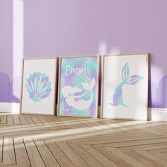 three framed pictures with mermaid images on them in front of a purple and blue wall