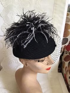 "Vintage 1970's dark Black Wool Felt hat. Has veiling with Black and White feathers. Label is *Miss Bierner*. Made in USA. *MORE INFORMATION BELOW* CONDITION: No issues noted. MEASURES: Inside circumference~21\" Front to back~7\" Left to right~8\" *WE APOLOGIZE~BUT WE NO LONGER SHIP TO GERMANY, ITALY OR SPAIN. IF ORDERS COME IN FROM GERMANY, ITALY OR SPAIN, WE WILL HAVE TO CANCEL THEM AND REFUND YOUR MONEY. SORRY FOR THIS INCONVENIENCE*" Vintage Wide Brim Mini Hat For Fall, Vintage Top Hat For Fall Party, Black Brimmed Fall Costume Hat, Black Brimmed Costume Hat For Fall, Brimmed Black Costume Hat For Fall, Vintage Black Hat For Fall, Fitted Black Costume Hats For Fall, Fitted Black Costume Hats And Headpieces For Fall, Retro Black Mini Hats For Party