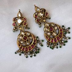 The listing includes a pair of earrings in ruby and in small size. The image attached is the inspirational image. It is under production and is going to be 85-90% same as the attached image with the same stone color and bead combination. Gold-plated on high-quality brass as base metal. Made by order. Kindly allow 8-9 weeks for the delivery of this item. For custom or urgent requests, please contact support@alacouture.com. *Please Note: We use faux stones and beads in all of our jewelry. Bollywood Style Designer Earrings With Cutdana, Designer Kundan Earrings For Diwali, Bollywood Cutdana Earrings For Designer Wear, Bollywood Designer Cutdana Earrings, Gold Chandbali Danglers For Designer Wear, Designer Tilla Earrings For Diwali, Designer Chandbali Earrings For Festive Occasions, Designer Chandbali Earrings With Latkans, Designer Chandbali Earrings For Diwali