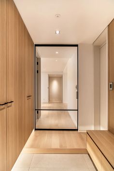 an empty hallway with wood and glass doors