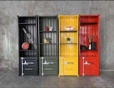 three different colored storage cabinets with baseballs on the top and bottom shelves in each