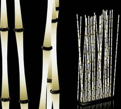 three tall white bamboo poles in front of a black background with the same design on it