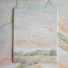 two watercolor paintings of birds flying in the sky