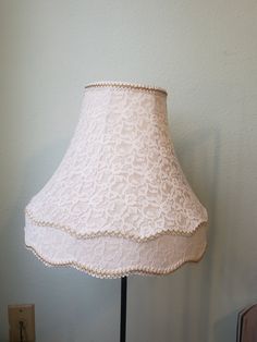 a lamp that is on a table next to a wall with a light in it