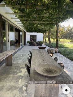 a wooden table sitting on top of a patio