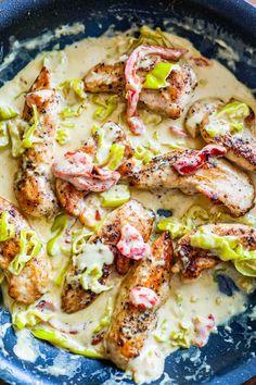 chicken with creamy sauce and lettuce in a blue bowl on a wooden table