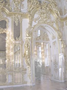 an ornately decorated room with white walls and gold trim