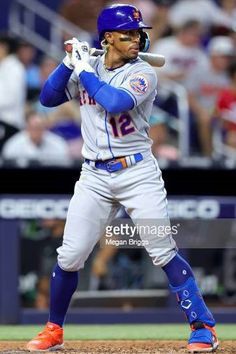 the baseball player is getting ready to swing his bat at home plate during a game