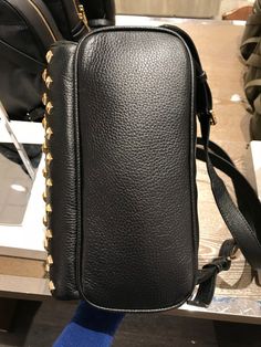 Michael Kors Women's Abbey Medium Studded Leather Backpack Black 35T8GAYB2L Pebbled leather with studded accent 100% polyester lining Gold tone hardware Zip closure Exterior features 1 zip pocket in front and 2 slide pockets on side Interior features 1 zip pocket, 1 large slip pocket and 2 multi-function slip pockets 23cm (W) x 30cm (H) x 11cm (D) Designer Leather Shoulder Backpack, Luxury Backpack With Gold-tone Hardware For Everyday Use, Designer Leather Backpack With Zipper, Rectangular Leather Bag With Rivets, Luxury Leather Backpack With Gold-tone Hardware, Designer Leather Backpack With Adjustable Strap For Daily Use, Michael Kors Leather Backpack With Zipper, Leather Backpack With Gold-tone Hardware For On-the-go, Luxury Shoulder Backpack With Gold-tone Hardware