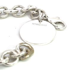 Authentic Tiffany & Co Estate Bracelet 6.75" Sterling Silver TIF526This elegant Authentic Tiffany & Co bracelet is made of sterling silver and has a weight of 33.7 grams.TRUSTED SELLER SINCE 2002PLEASE SEE OUR HUNDREDS OF POSITIVE FEEDBACKS FROM OUR CLIENTS!!FREE SHIPPING!!DETAILSStyle: BraceletLength: 6.75 InchesWeight: 33.7 GramsMetal: Sterling SilverWe try to present our Tiffany estate items as best as possible and most have been newly polished some of the Tiffany items may have a natural pat Sterling Silver Jewelry With Silver-tone Logo, Luxury Sterling Silver Charm Bracelet For Formal Occasions, Luxury Engraved Sterling Silver Bracelet, Luxury Hallmarked Sterling Silver Bracelet, Classic Silver Charm Bracelet With Polished Finish, Classic White Gold Charm Bracelet With Polished Finish, Classic Round Charm Bracelet With Polished Finish, Luxury Silver Charm Bracelet With Polished Finish, Timeless Silver Bracelet With Shiny Finish