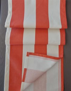 two orange and white striped towels folded on top of each other