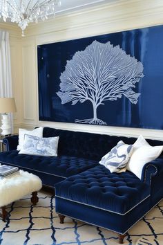 a living room with a blue couch and white rug