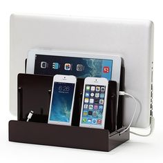 an electronic device charging station with three cell phones