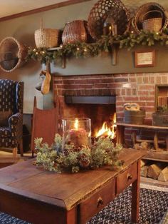 a living room filled with furniture and a fire place covered in christmas wreaths on the mantle