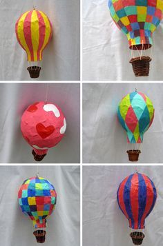 four different hot air balloons are shown in various colors and shapes, each with a heart on them