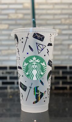 the starbucks cup is decorated with different symbols