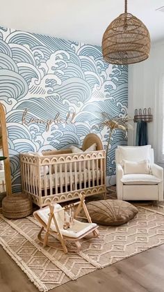 a baby's room with a crib, rocking chair and large wallpaper