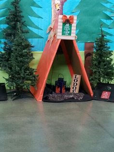 there is a fake teepee tent with trees on it and decorations around the base