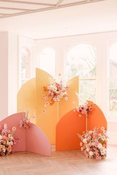 an arrangement of flowers on display in front of a window