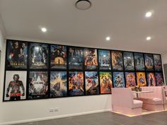 a large movie poster on the wall next to a dining room table and two chairs