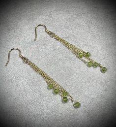 These gold peridot earrings feature 10 3mm peridot beads in 14k gold filled wire and chain.  These August birthstone earrings are genuine peridot gemstones, non-tarnish, and perfect for any occasion.  About the Earrings: - Non-tarnish 14k gold filled wire, chain, and ear wires - Genuine peridot - Handmade - Safe for daily wear - Suitable for those with metal allergies or sensitivities THESE EARRINGS ARE MADE TO ORDER Please allow an additional 1-3 days for handmade creation of your jewelry.  Made-to-order pieces are made with gemstones of the same size, shape, color, and quality as the original in the photos.  As these are natural gemstones, there may be some slight variation in color and/or color pattern. Return policy: - Our work is guaranteed!  We offer repair services as well as interm Metal Dangle Earrings For May Birthstone, Dangle Metal Jewelry For May Birthstone, May Birthstone Dangle Metal Jewelry, Wire Wrapped Dangle Earrings For Anniversary, Gold Long Drop Crystal Earrings Nickel Free, Gold Nickel-free Long Drop Crystal Earrings, Dangle Earrings With May Birthstone In Metal, Metal Earrings For May Birthstone Gift, Wire Wrapped Dangle Earrings For May Birthstone