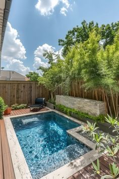 a backyard with a small pool and wooden decking, surrounded by greenery on both sides