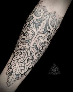 a black and white tattoo design on the arm