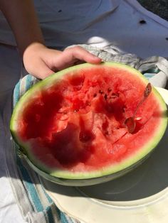 a watermelon is cut in half on a plate