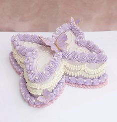 two decorated cookies sitting on top of a white table